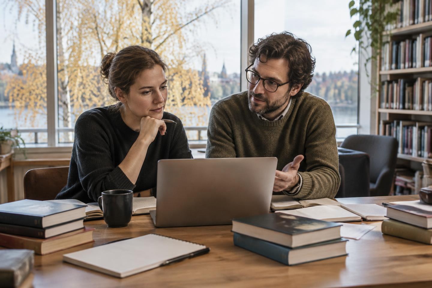 AI-generated editorial illustration: Postdoctoral researchers discussing academic work in a Nordic study room.
