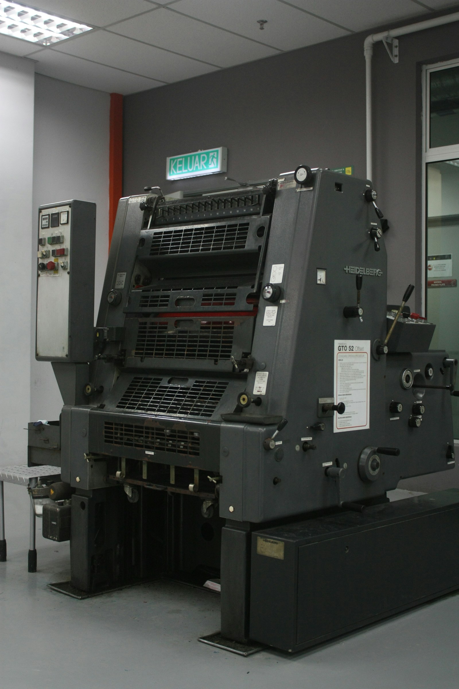 Illustrative photograph of an offset printing press in a production room.